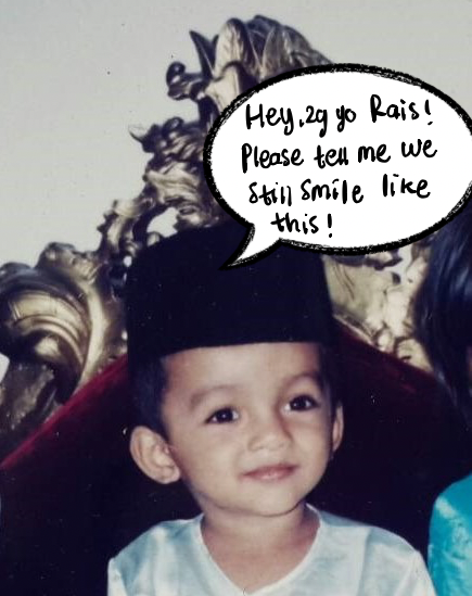 Little Rais in a black songkok and baby blue baju melayu